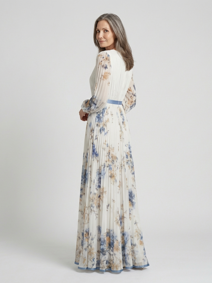 Back view of the ivory floral dress with blue waistband and pleated skirt