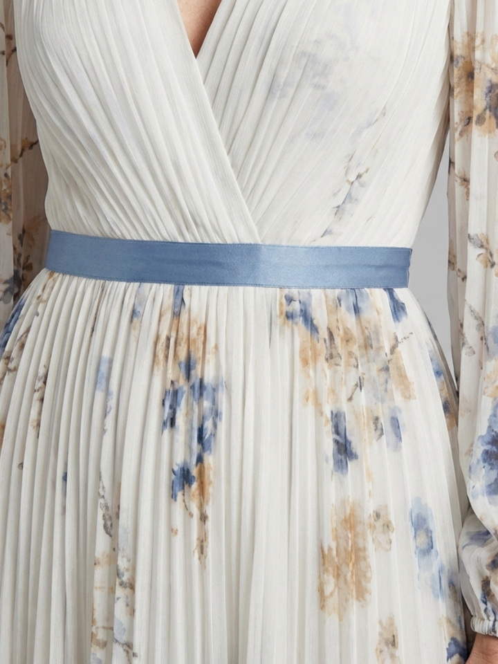 Close up of the pleated bodice, blue waist band and floral print
