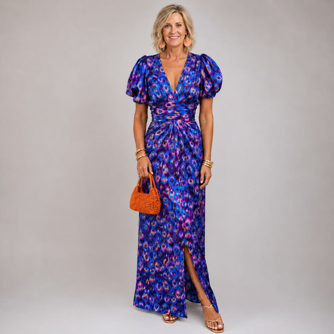 Blue print dress styled with an orange beaded bag and tan sandals
