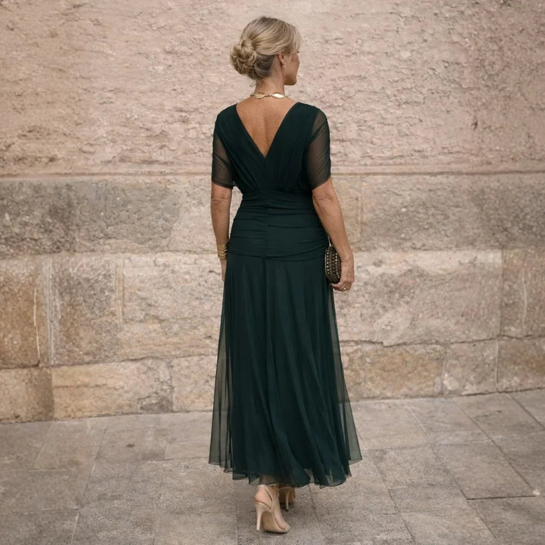 Back view with the deep V back and sheer sleeves in dark green