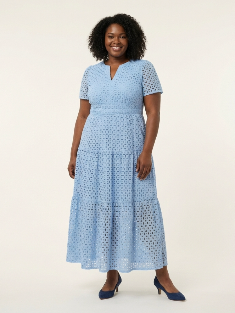 Sky blue broderie dress worn with navy heels by a curvier model