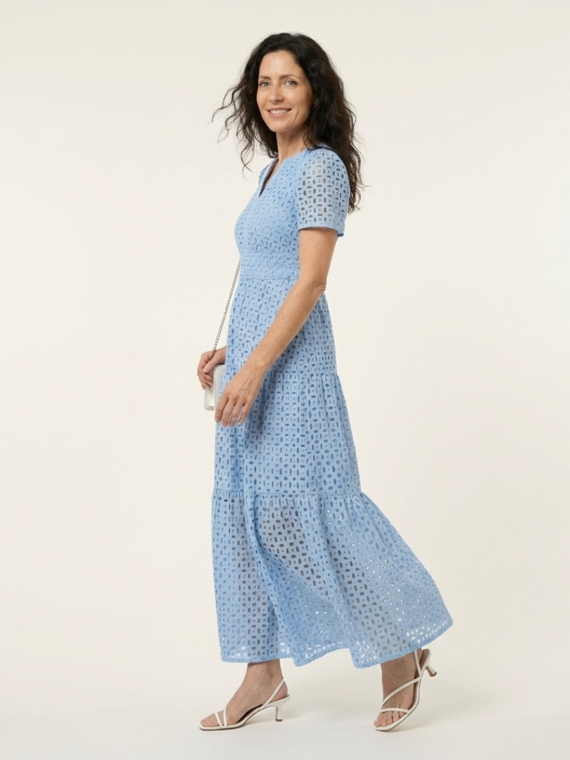 Side view of the blue eyelet dress showing the swinging tiers