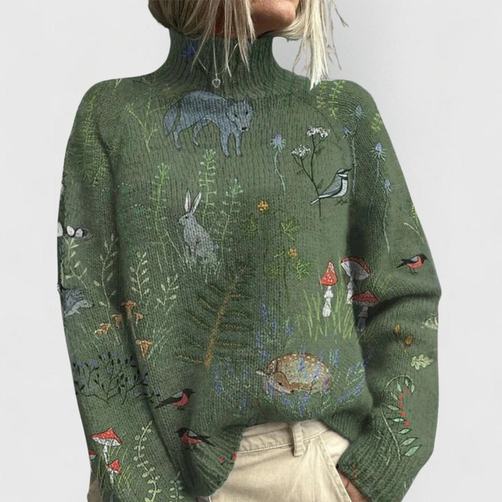 Sage green jumper with a woodland print of foxes, hares and birds