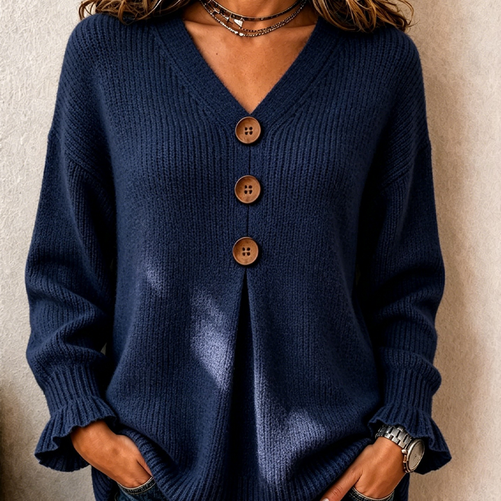 Close up of navy knitted jumper with V neck and three buttons