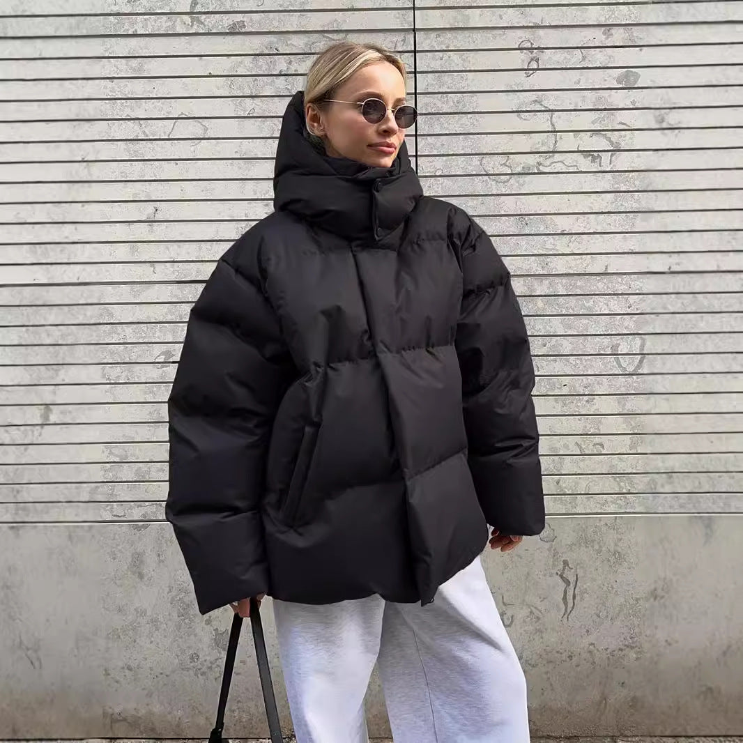Black hooded puffer jacket zipped with the hood up