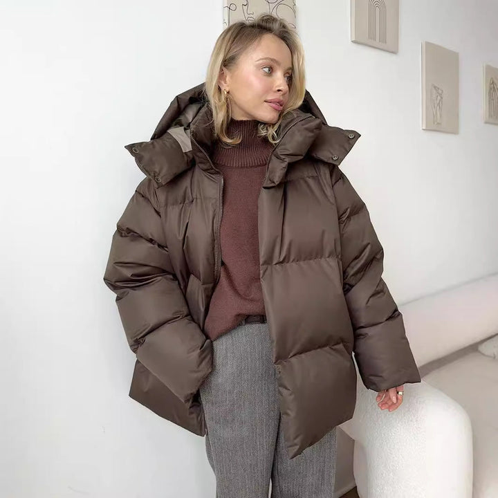 Dark brown oversized puffer jacket over a roll neck jumper