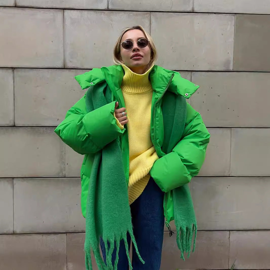 Bright green puffer jacket styled with a yellow knit and scarf