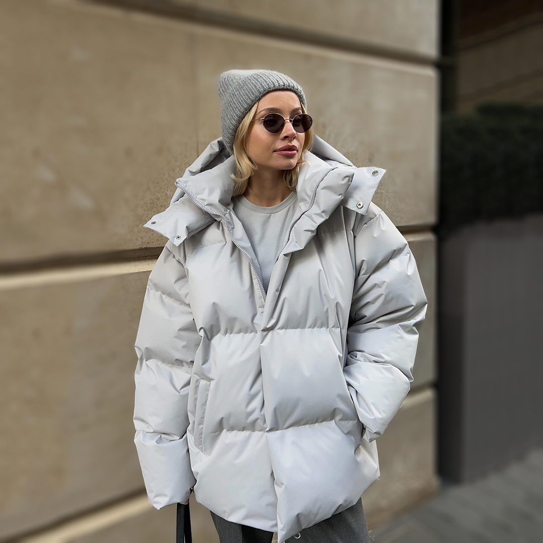 Light grey oversized puffer with the hood resting on the shoulders