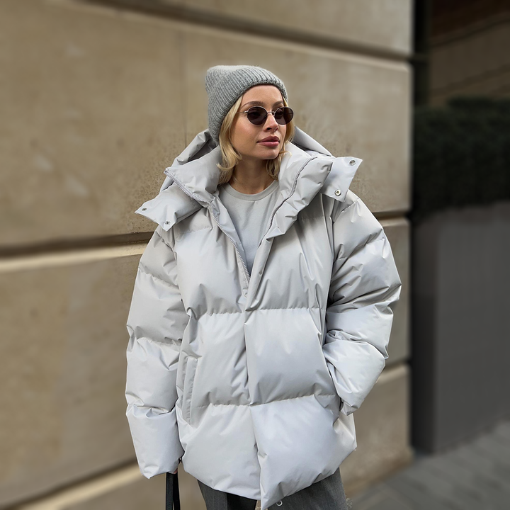 Light grey oversized puffer with the hood resting on the shoulders