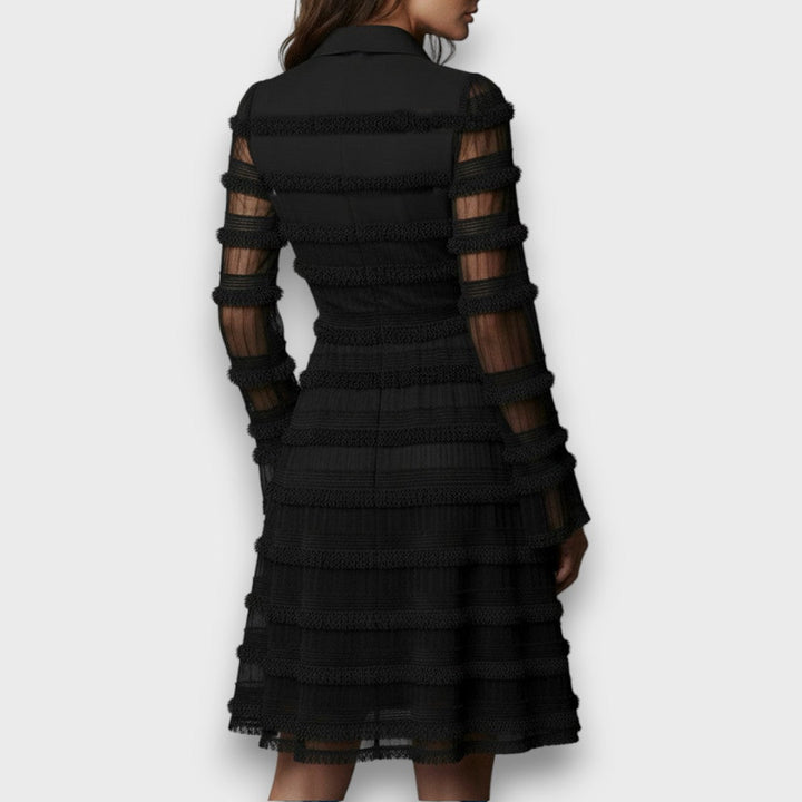 Back view of the black dress with sheer striped sleeves