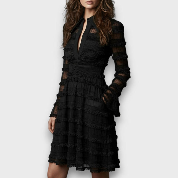 Black fringe midi dress seen from a three quarter angle