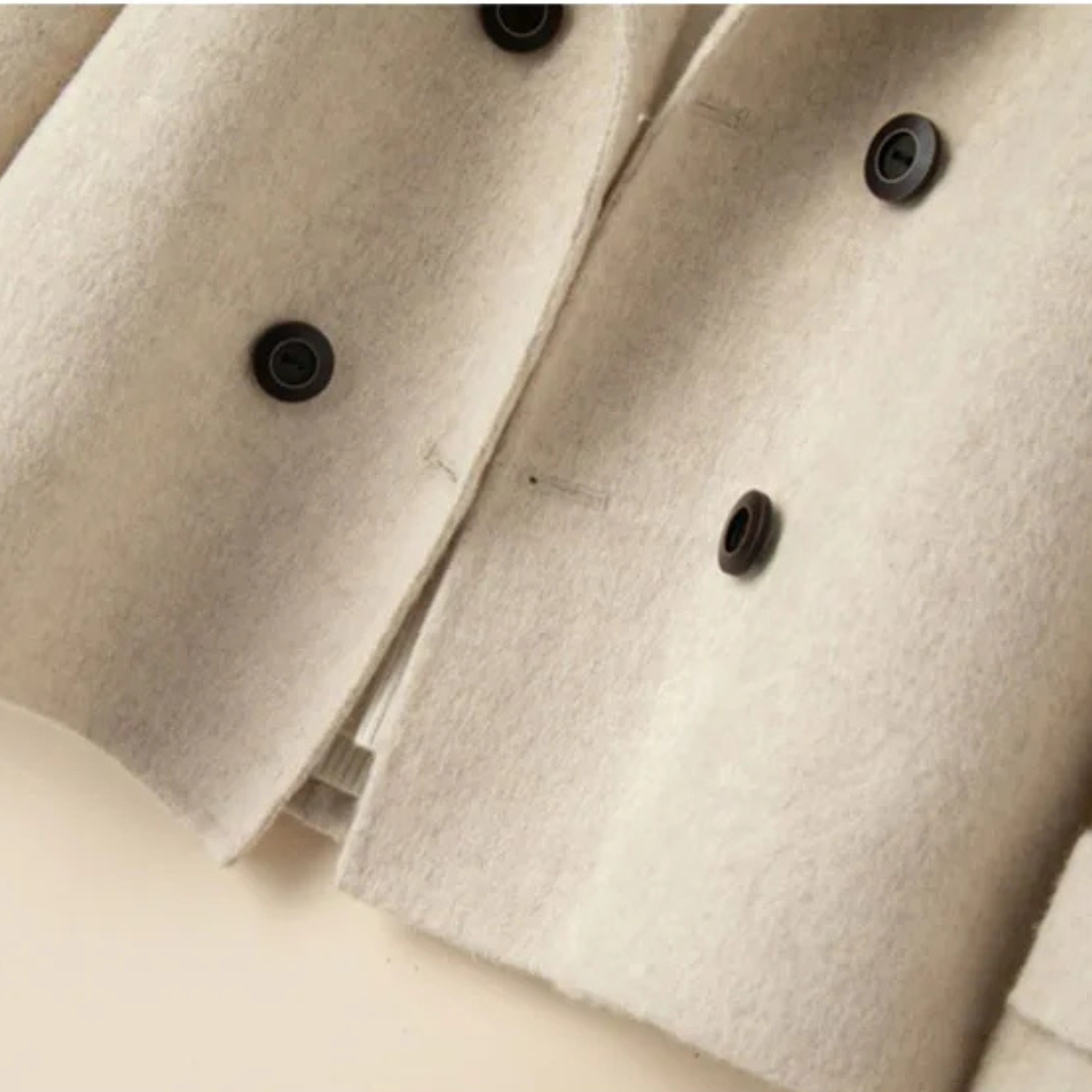 Close up of the cream coat front showing the dark buttons