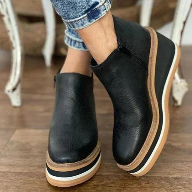 Black wedge ankle boot with side zip worn