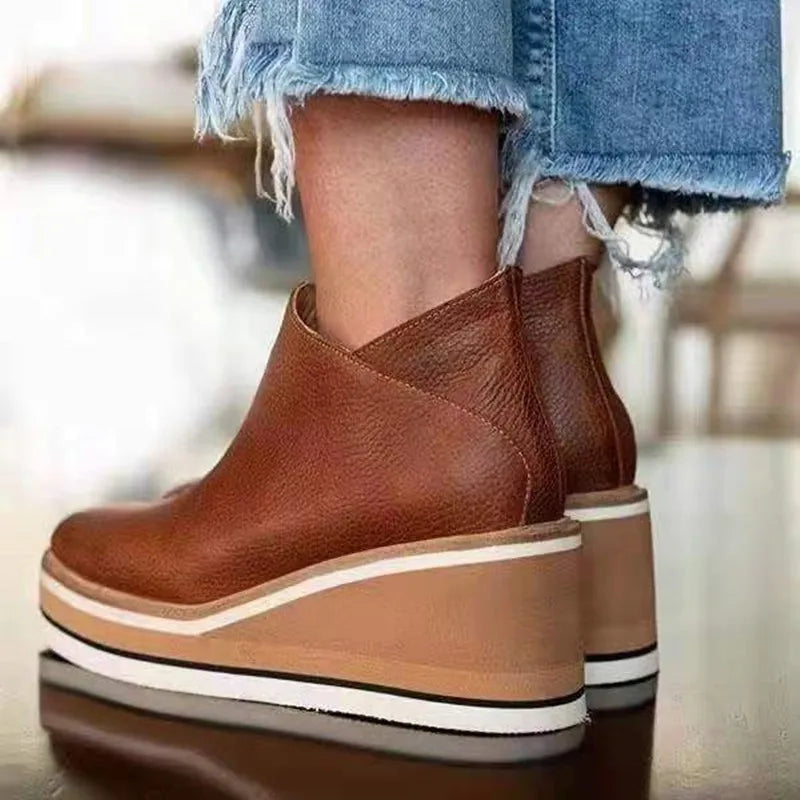 Side view of the cognac boot showing the cream and black stripe sole