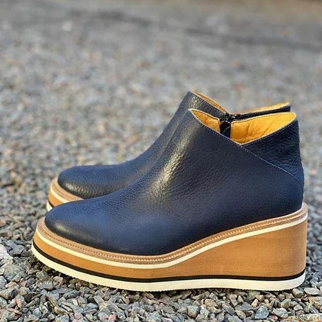 Navy platform wedge ankle boot with wooden-look wedge on gravel