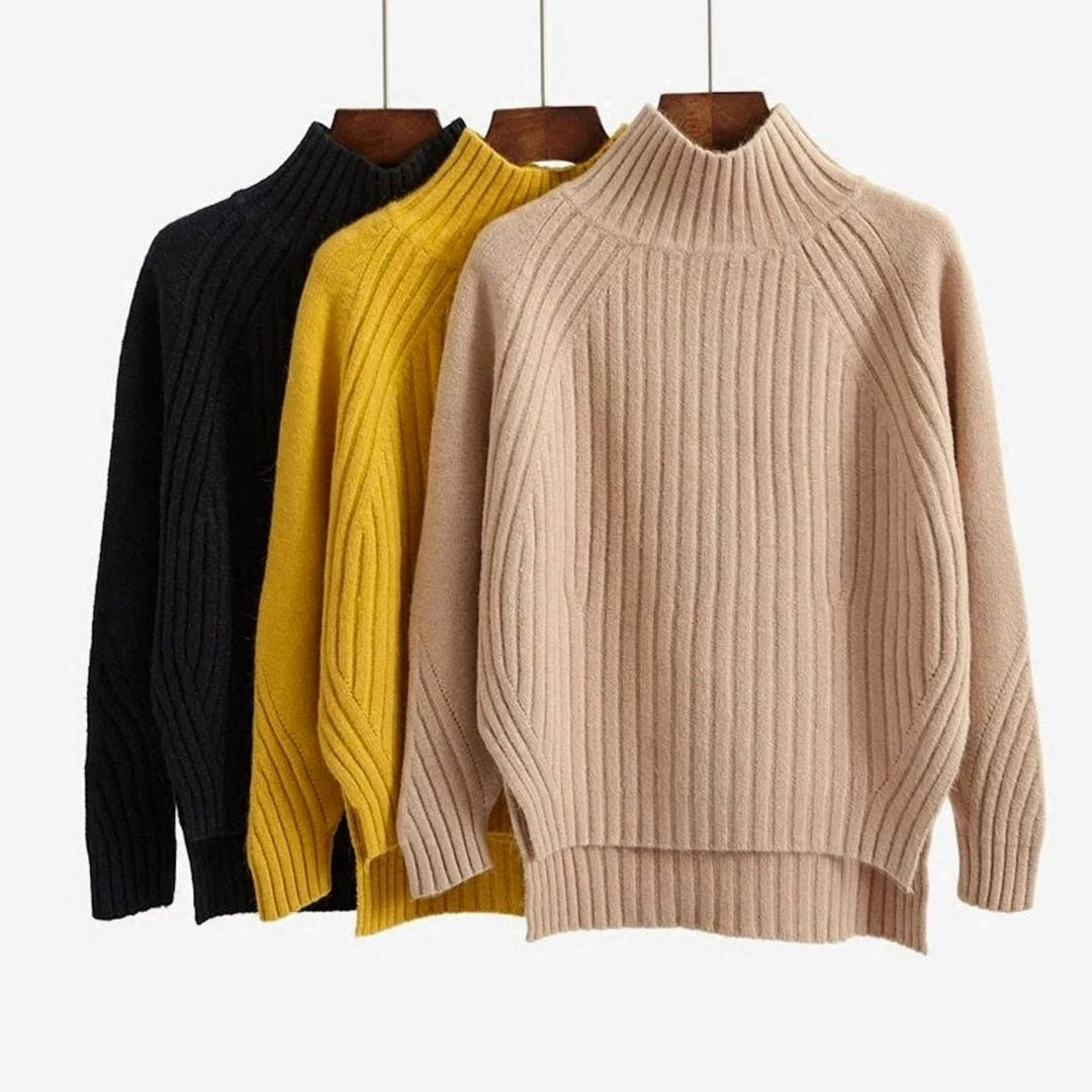 Black, mustard and camel versions of the jumper hanging side by side