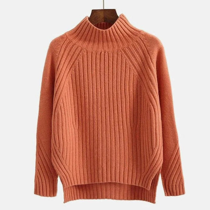 Rust ribbed jumper on a hanger showing the raglan seams and high neck
