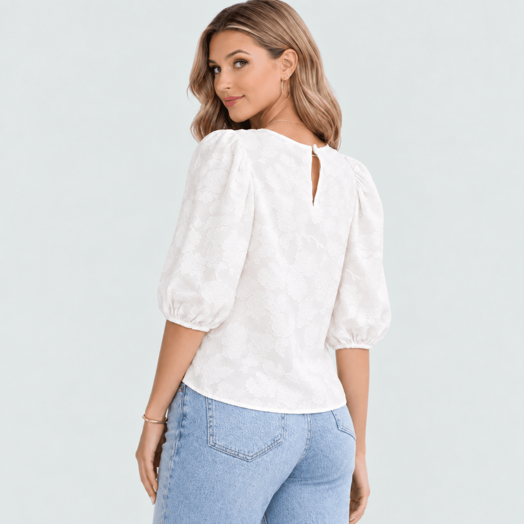 Back of the white blouse with a keyhole and single button