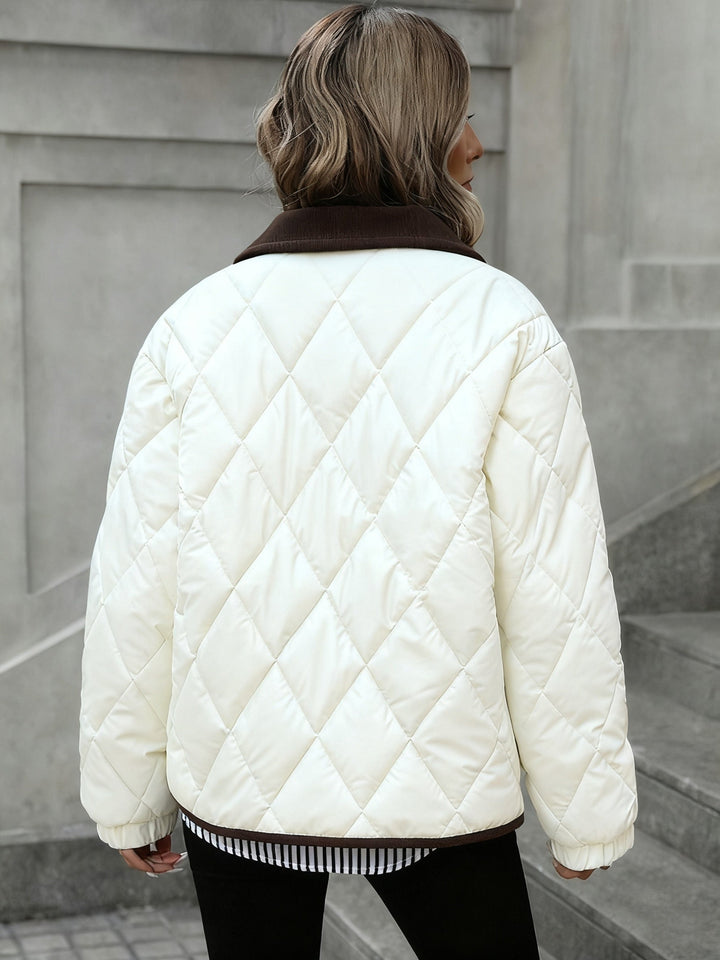 Back view of the cream quilted jacket with brown trimmed hem