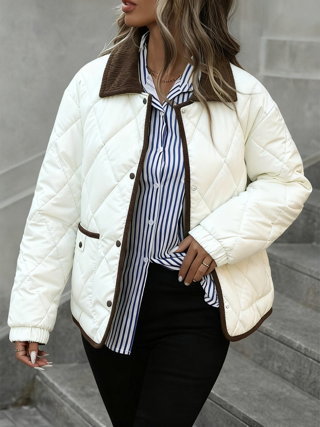 Cream jacket at an angle showing the snap tab pocket