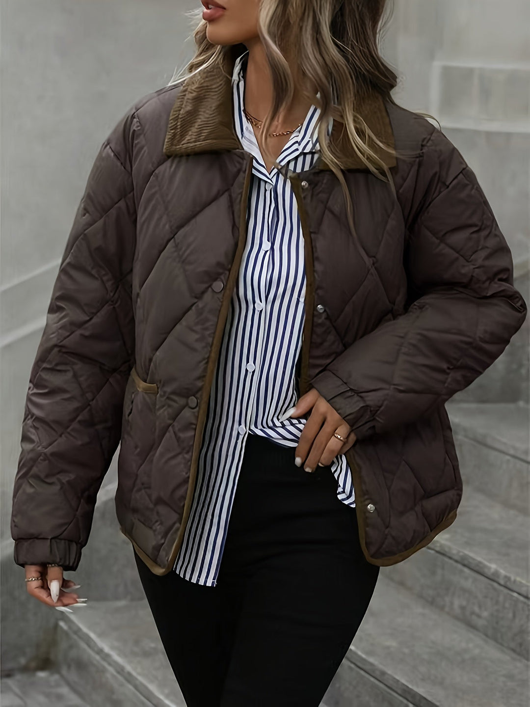 Model in the dark brown jacket worn open over a striped shirt