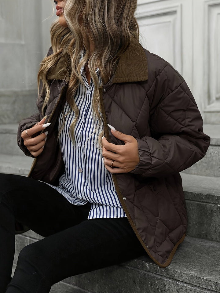 Dark brown quilted jacket seen from the side on stone steps