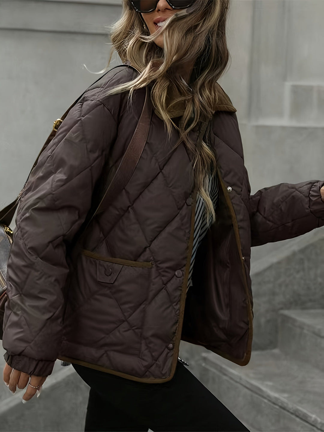 Dark brown jacket styled with a shoulder bag and sunglasses