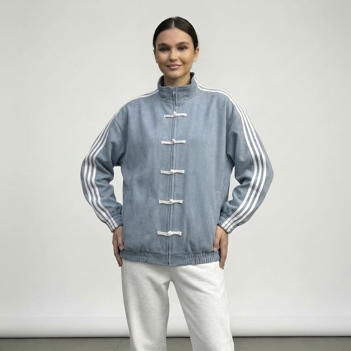 Light blue track jacket with hands on the hips