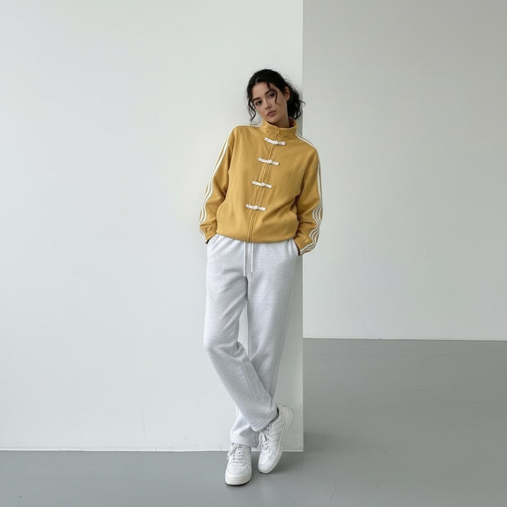 Full length look of the mustard track jacket with trainers