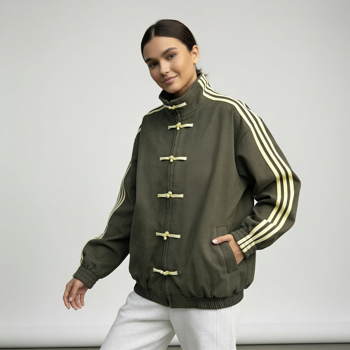 Olive green track jacket with pale yellow stripes and toggles