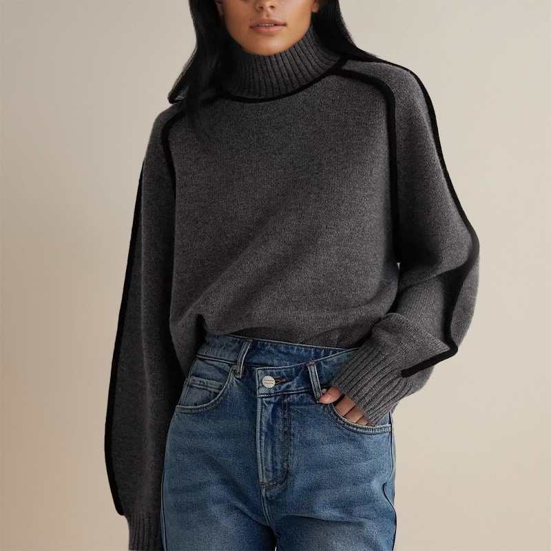 Charcoal grey roll neck jumper with black piping, worn with denim
