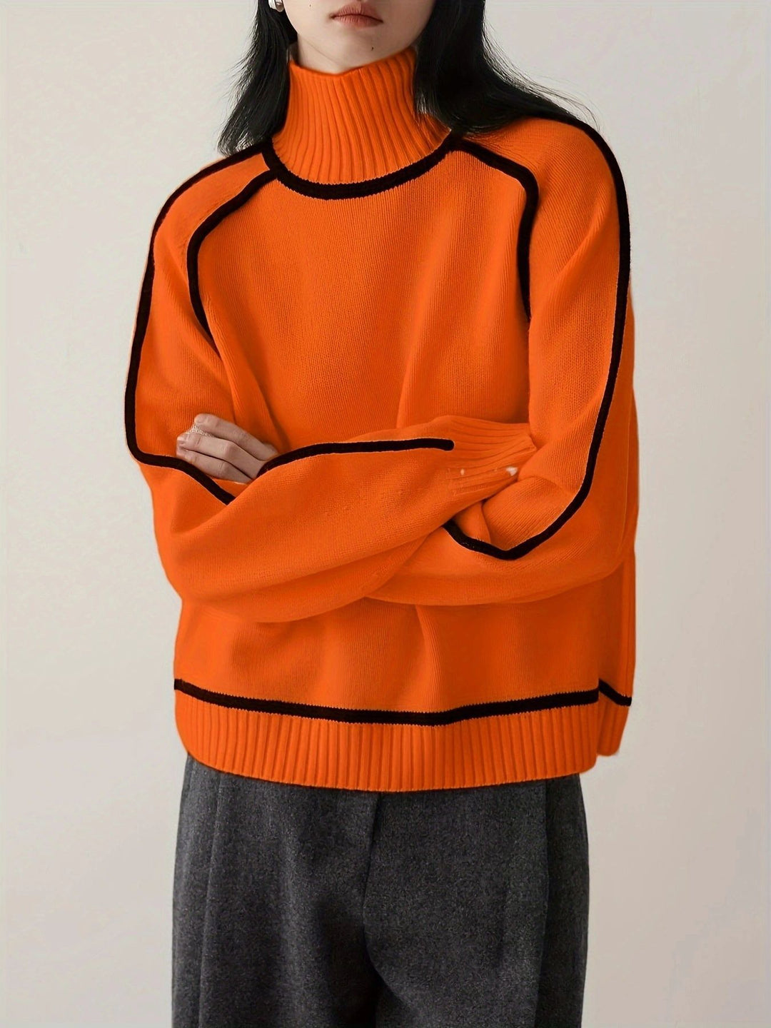 Orange oversized roll neck jumper with black piped seams and hem