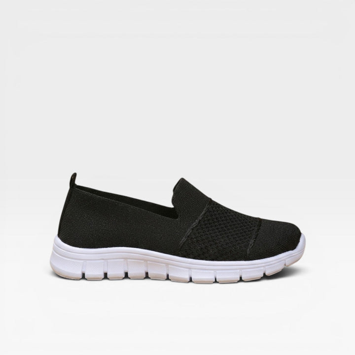 Black slip on trainers with a white cushioned sole