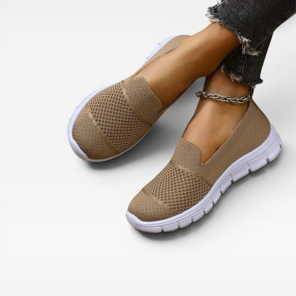 Model wearing camel knit trainers with frayed cropped jeans