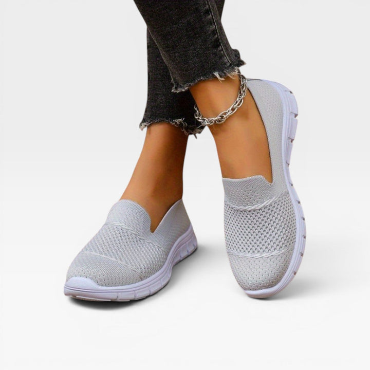 Front view of light grey knit trainers on the model