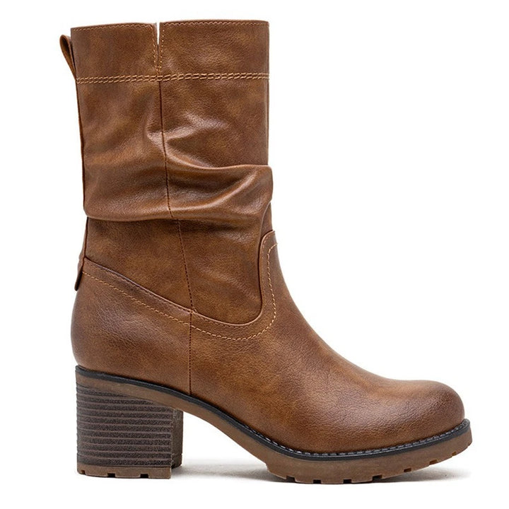 Brown slouch boots, three quarter view on a plain background