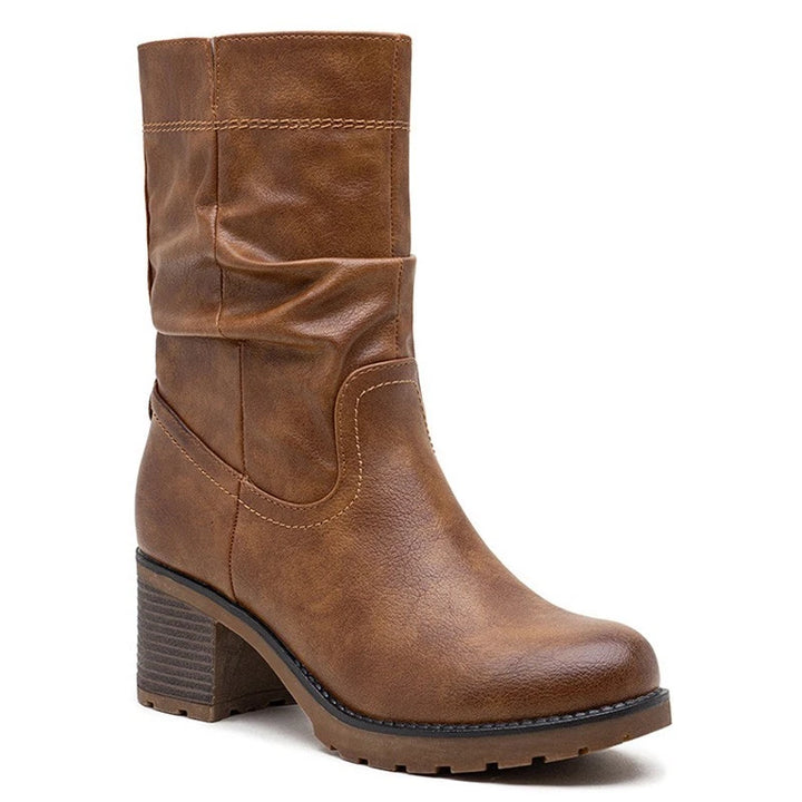 Brown slouch boots, side view on a plain background