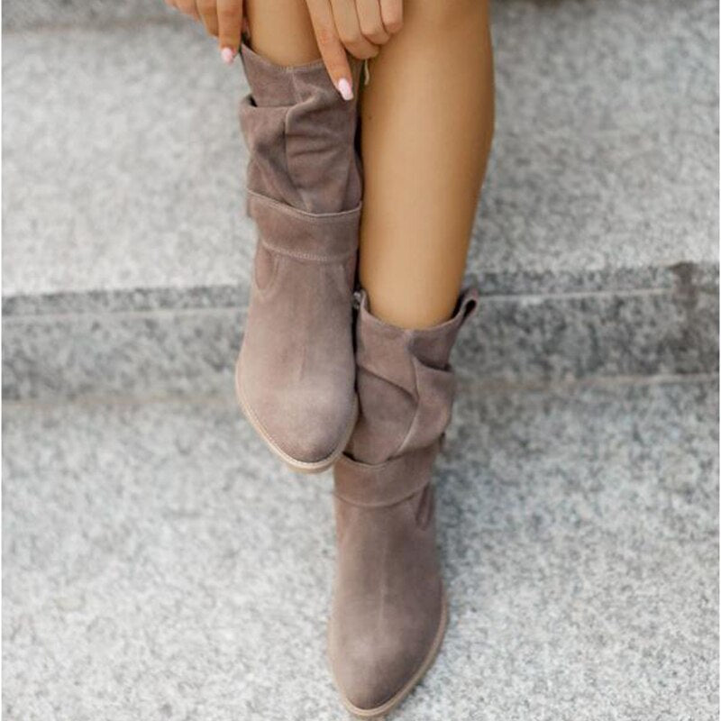 Grey slouch boots worn on stone steps