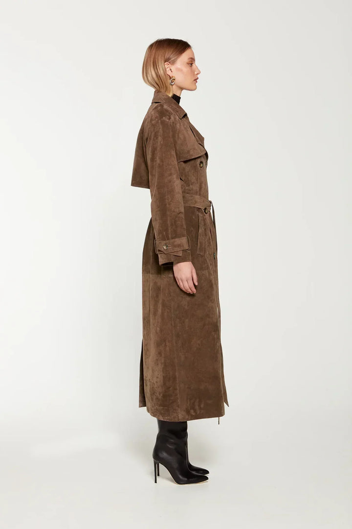 Side view of the brown maxi trench coat falling to the ankle