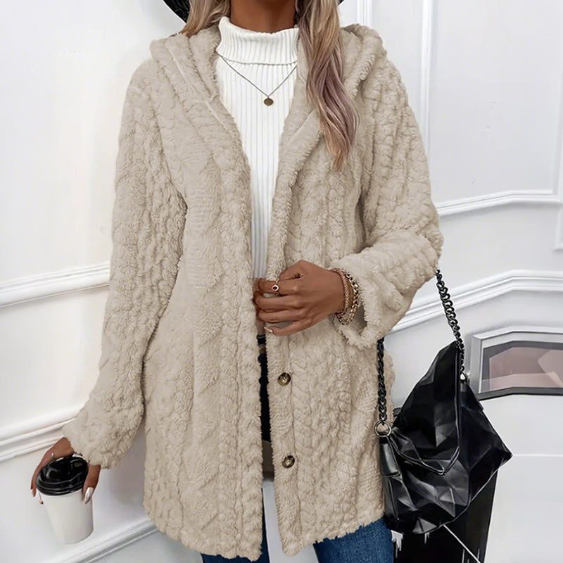 Beige teddy coat buttoned at the waist, showing the embossed cable pattern