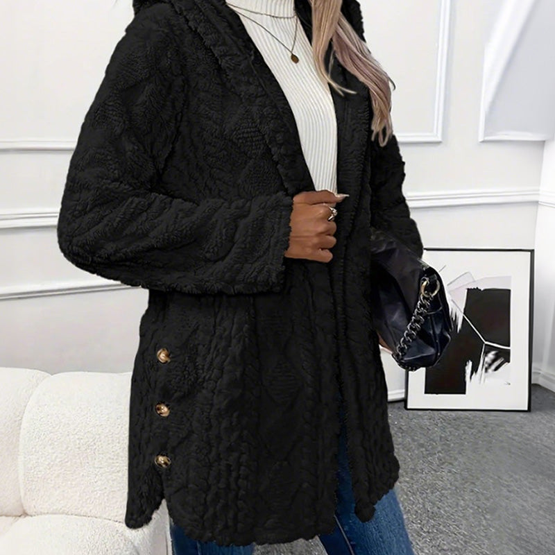 Black coat from the side, mid thigh length with buttons on the hem