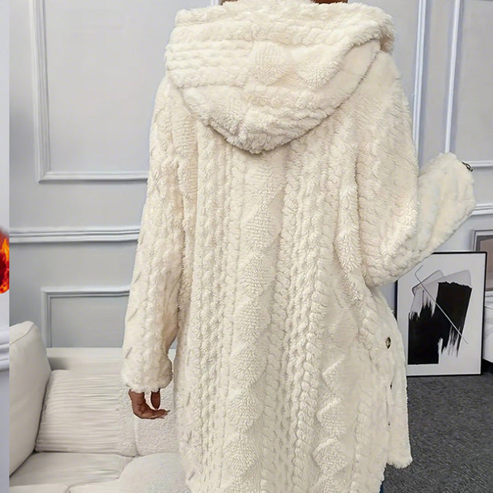 Back of the cream coat with the attached hood and cable pattern