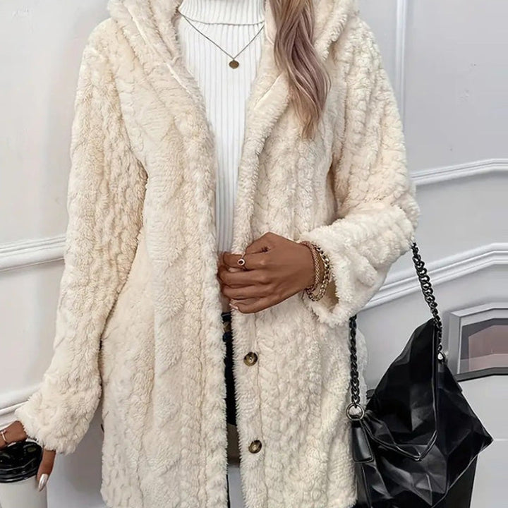 Cream teddy coat worn open, plush pile and dark buttons along the front