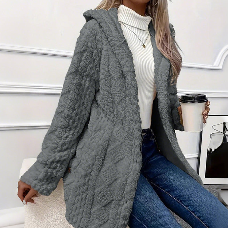 Grey teddy coat worn open, the cable texture catching the light