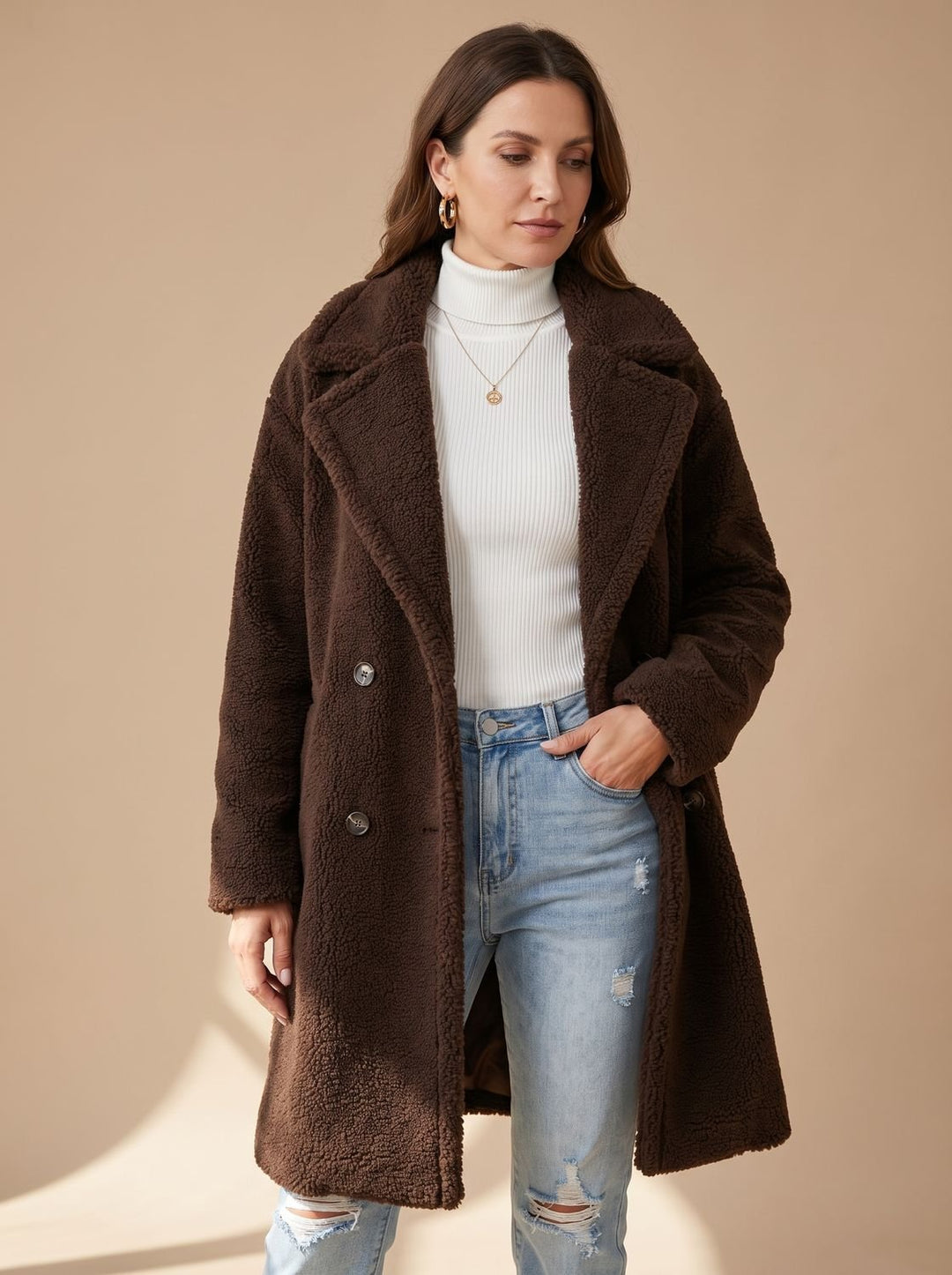 Dark brown teddy coat buttoned up, hand resting in the pocket