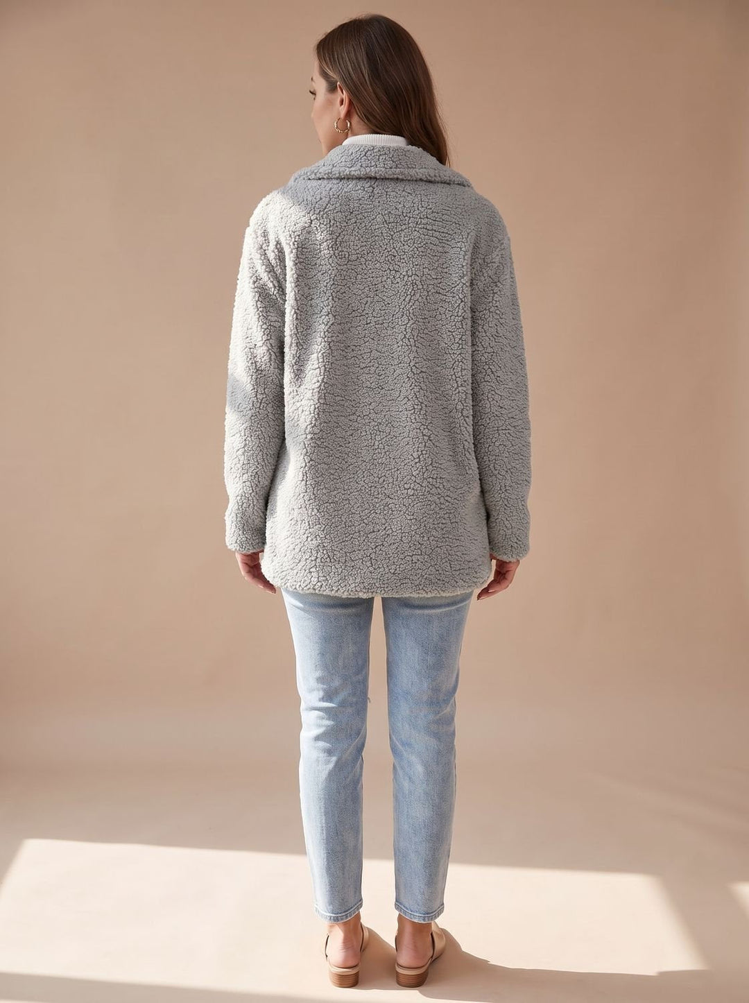 Back view of the light grey teddy coat showing the plush pile