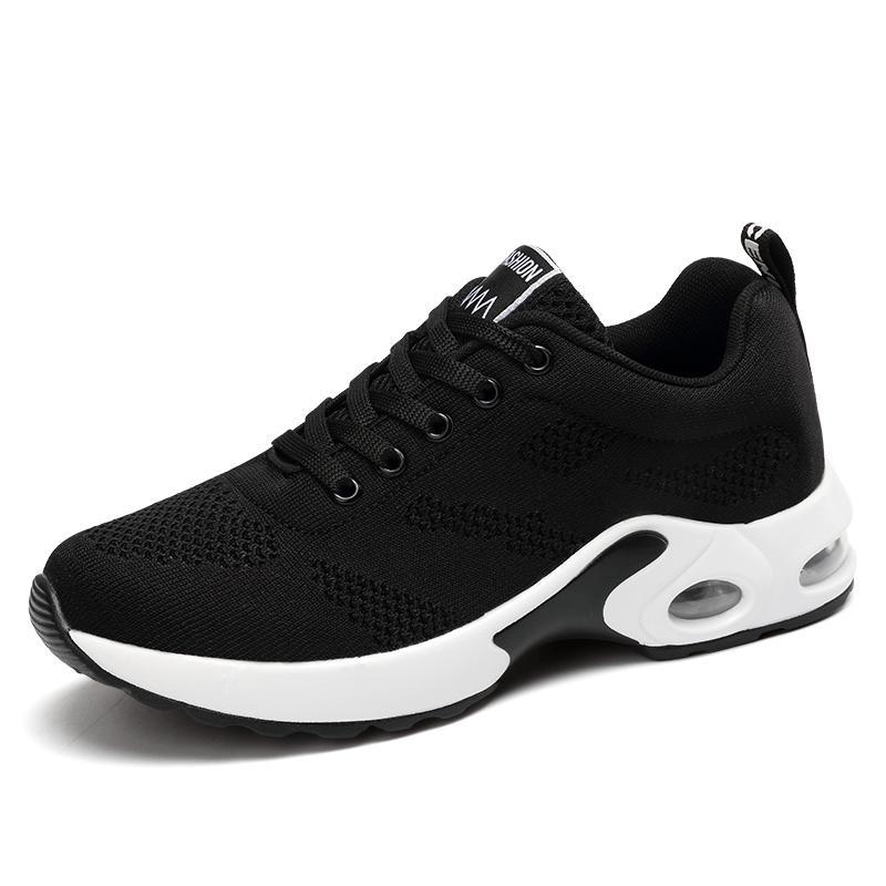 Black trainers, side view on a plain background