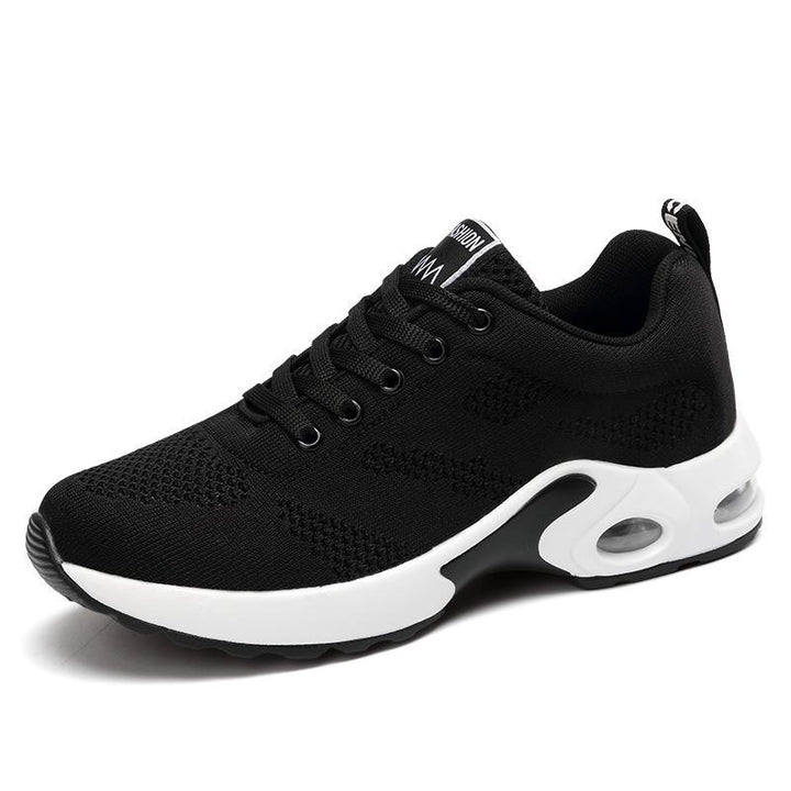 Black trainers, side view on a plain background