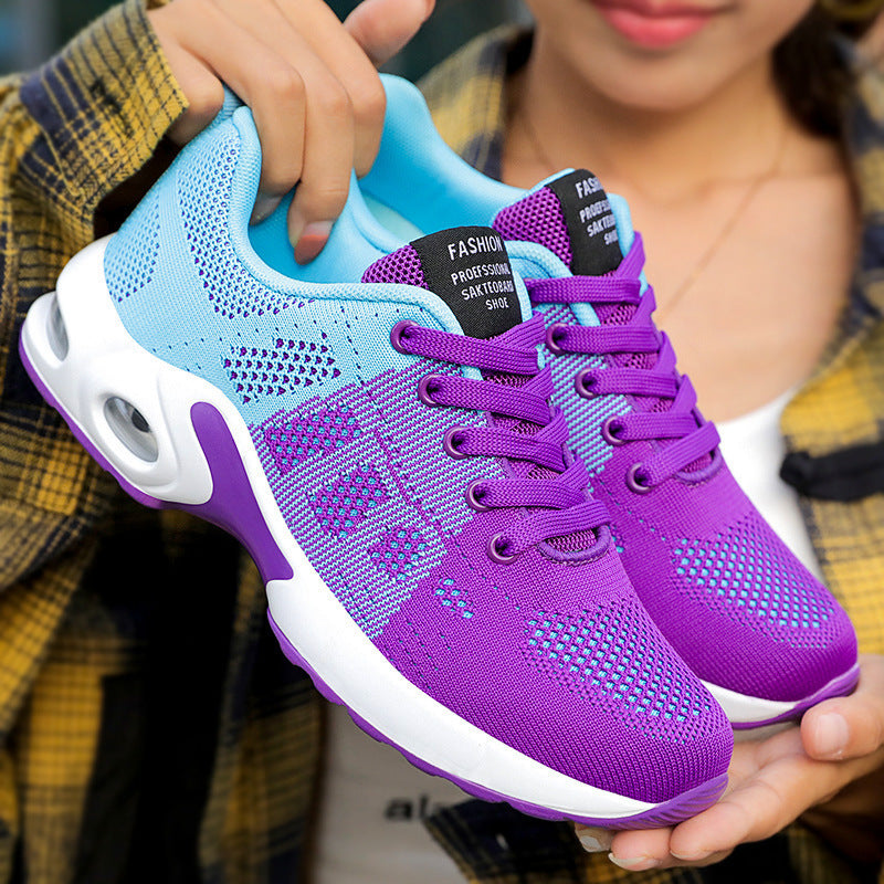 Blue Purple trainers, held up to show the inside and the sole