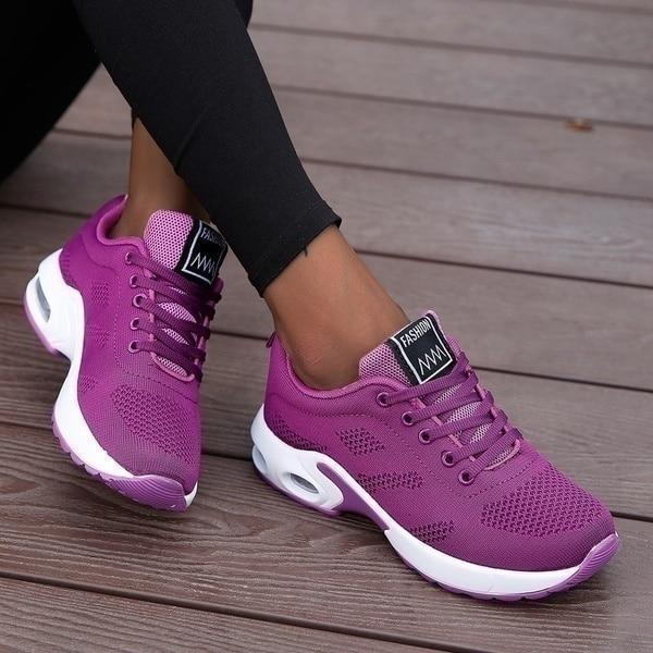 Plum trainers, worn on foot, front view
